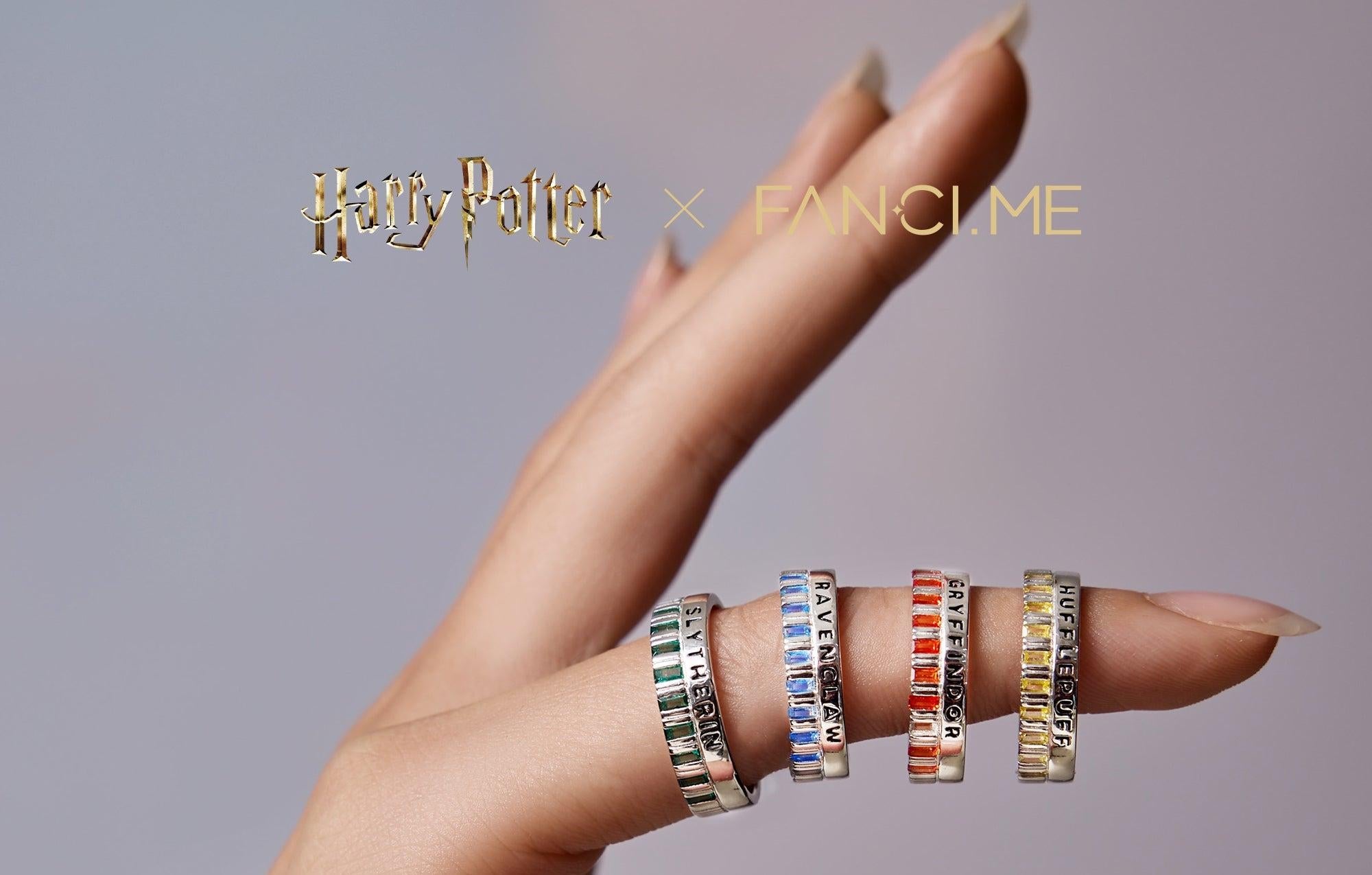 Promotional graphic showing colorful lettered rings worn on a finger, with “FANCY.ME” text above.
