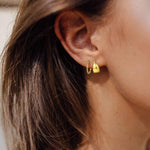 polished shiny yellow gold hoop earrings try on